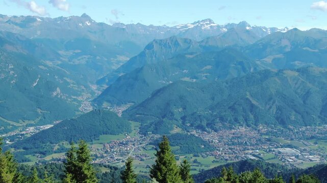 Rovetta and plateau of Clusone, alpine landscape, mountain range in background, Italy. Aerial drone panoramic view ion sunny day