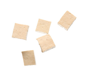 Pieces of flying tasty tofu cheese isolated on white background