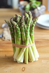 A bunch of fresh green asparagus on wooden table