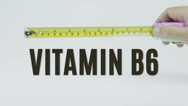 "Vitamin B6" text with a yellow tape measure on a white background, symbolizing precision, accuracy, and nutrient measurement in a clean, minimal video