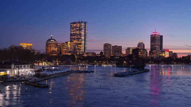 Boston city skyline with high-rise buildings seen from  Longfellow bridge over Charles river during winter sunset