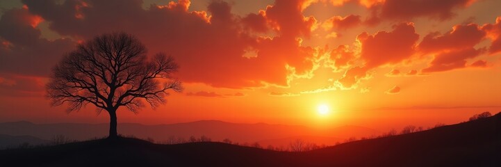 Fototapeta premium A breathtaking sunset over rolling hills, featuring a solitary tree silhouetted against vibrant clouds. Perfect for nature, travel, and lifestyle themes.