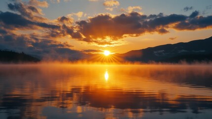Obraz premium Serene Sunrise Over Calm Lake with Mist and Golden Reflections