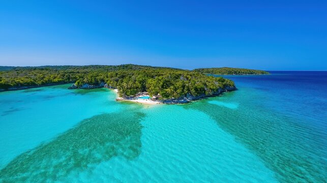 Lush tropical island with turquoise waters under a clear blue sky
