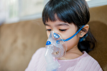 Girl using Oxygen breathing machine at home smile and surprice. Breathing device for asthma and coronavirus. Woman have problem with lungs	