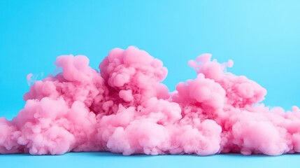 Fototapeta premium Puffs of pink smoke against a vibrant blue background creating a striking visual effect and contrast