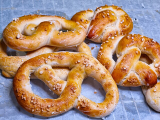Freshly homemade salty pretzels on baking tray with waxed paper 