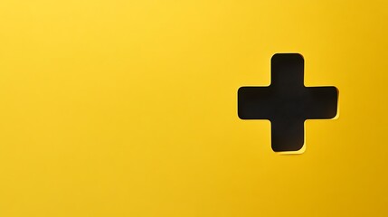 Obraz premium Yellow background with black plus symbol cutout.