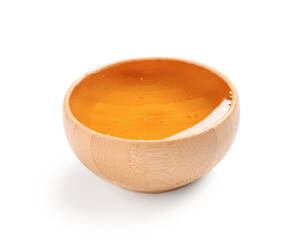 Wooden bowl with sweet honey on white background