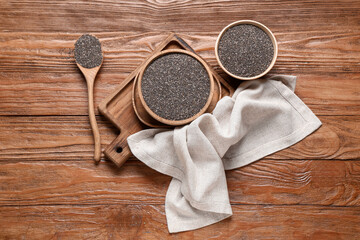 Bowls and spoon with chia seeds on wooden background