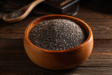 Bowl with chia seeds on wooden background, closeup