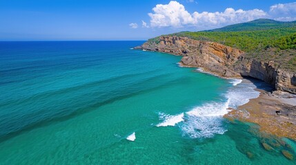 Obraz premium Scenic aerial view depicts coastline featuring cliffs forest and turquoise water
