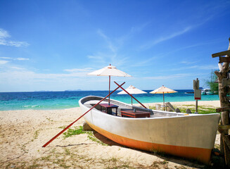 Wooden boat by the sea on a beautiful sky background