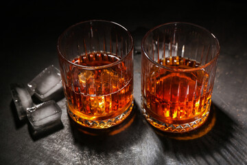 Glasses of cold rum on grey grunge background