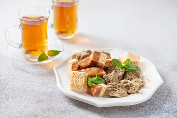 Oriental sweetness.  Nougat, halva and  tea on a table.