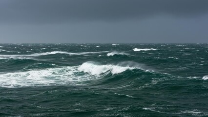 Fototapeta premium Dramatic ocean waves under stormy skies create a moody atmosphere.