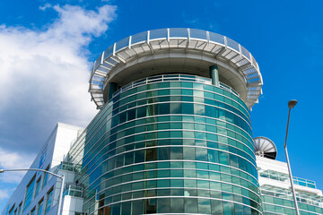 Fototapeta premium Glass tower building. Architectural design of building. Residential building architecture. Architectural exterior detail. Residential exterior fragment. Modern residential building