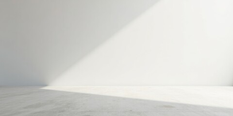 Obraz premium A Minimalist Empty Room with Sunlight Streaming Across the Floor and a Blank White Wall, Ideal for Product Placement or Design Presentations