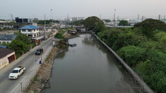Drone shot of the Rangsit Prayunsak canal and Rangsit - Nakhon Nayok Road during daytime, Thailand