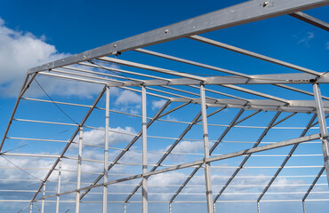 Framework construction architecture. Architectural detail. Installation of metal structure at cloudy sky. Metal construction. Structural design engineering. Structure engineering at building site