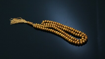 prayer beads made of wood on a black background