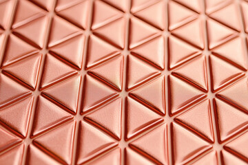Rose gold metallic texture with geometric patterns creates modern aesthetic. intricate design adds depth and elegance to any surface