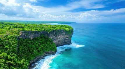 Lush green vegetation tops a dramatic coastal cliffside overlooking ocean