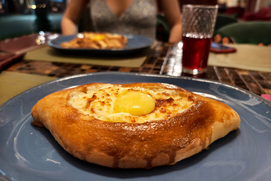 Traditional Georgian bread - khachapuri madjarski with cooker hand. Homemade baking. overhead.Khachapuri with cheese , georgian khachapuri megruli with cheese, Traditional Georgian pie cooking process