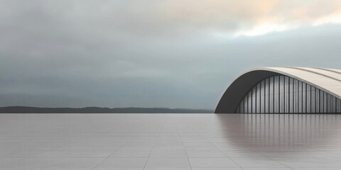 Modern architectural design with a sleek curved roof near the water under cloudy sky