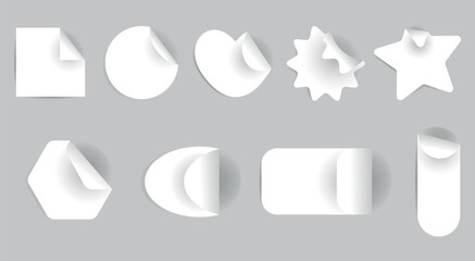Realistic set of white stickers of different shapes: square, circle, heart, star with a curved corner. Collection of vector classic paper adhesive sticker layouts