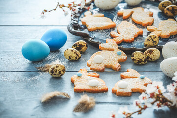 Homemade almond bunny cookies for Easter with Easter eggs in blue tone
