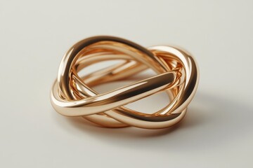 Naklejka premium A stunning rose gold knot ring, showcasing intricate weaving and a polished finish that glimmers beautifully.