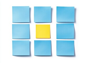 Fototapeta premium Eight light blue sticky notes arranged on a white background, with one vibrant yellow note standing out.