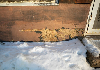 damaged building foundation surface plaster in winter