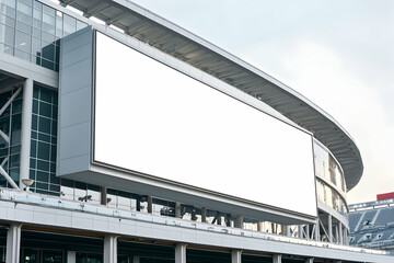 Large rectangular billboard on a football stadium facade, ideal for team or event advertising.