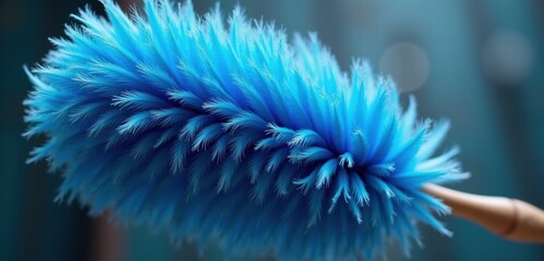 A vibrant blue duster, ideal for showcasing cleaning products or home care solutions. Its soft bristles capture dust effortlessly, perfect for promotions and advertisements.