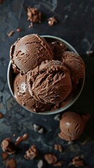 An enticing bowl of rich chocolate ice cream with smooth scoops promises pure bliss for chocolate lovers everywhere.