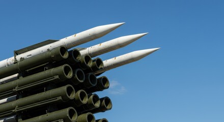 Rockets are arranged vertically, showcasing their design and technology at a defense event