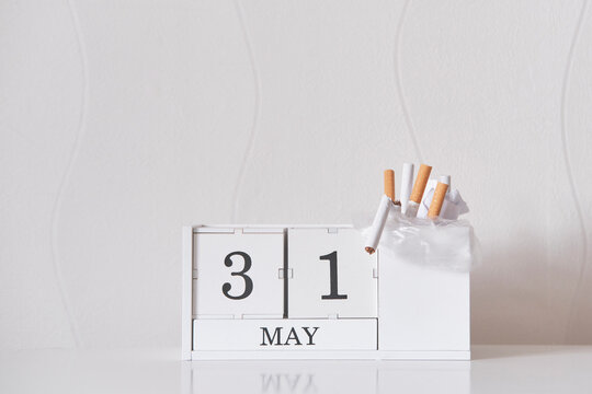 World No Tobacco Day concept with calendar and discarded cigarettes - Powered by Adobe