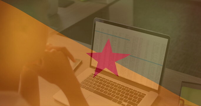 Analyzing financial data on laptop over image of french guiana flag - Powered by Adobe