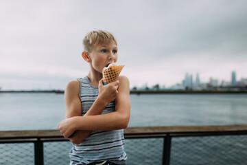 Child eating waffle cone of ice cream on Chicago boardwalk