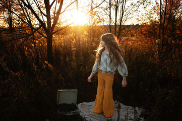 Beautiful tween long wavy hair dancing record player outdoors