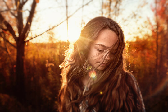 Up close beautiful tween long blonde wavy hair sunset