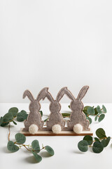 Decorative Easter bunnies with branch of eucalyptus. Easter background and wallpaper