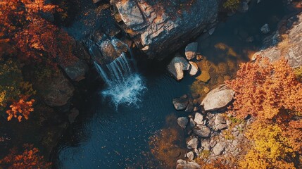 Autumn waterfall aerial view, rocky pool, colorful foliage