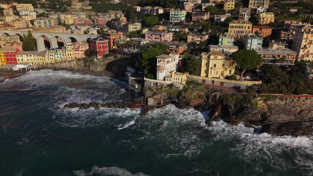 Bogliasco, liguria, showcasing colorful buildings and crashing waves, aerial view