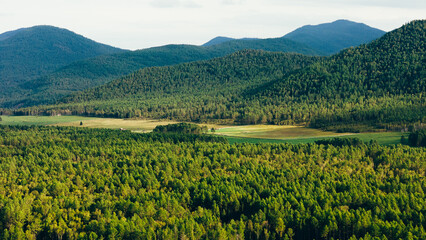 A river winding through mountains in Zakamensky District, Buryatia. Majestic peaks and serene natural beauty.