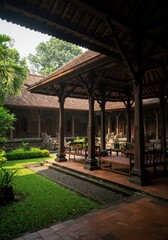 Obraz premium Lush greenery surrounds a tranquil courtyard with wooden architecture in Bali, inviting peace