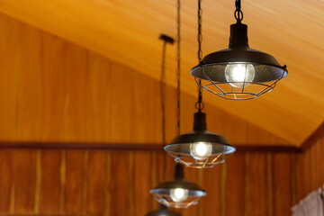 Three lighted lamps hanging from the ceiling