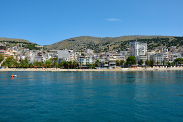 Sarande on the Ionian coastline of southern Albania, part of the Albanian Riviera. Here, the hills of the Ceraunian mountain range meet the Straits of Corfu in the eastern Mediterranean Sea